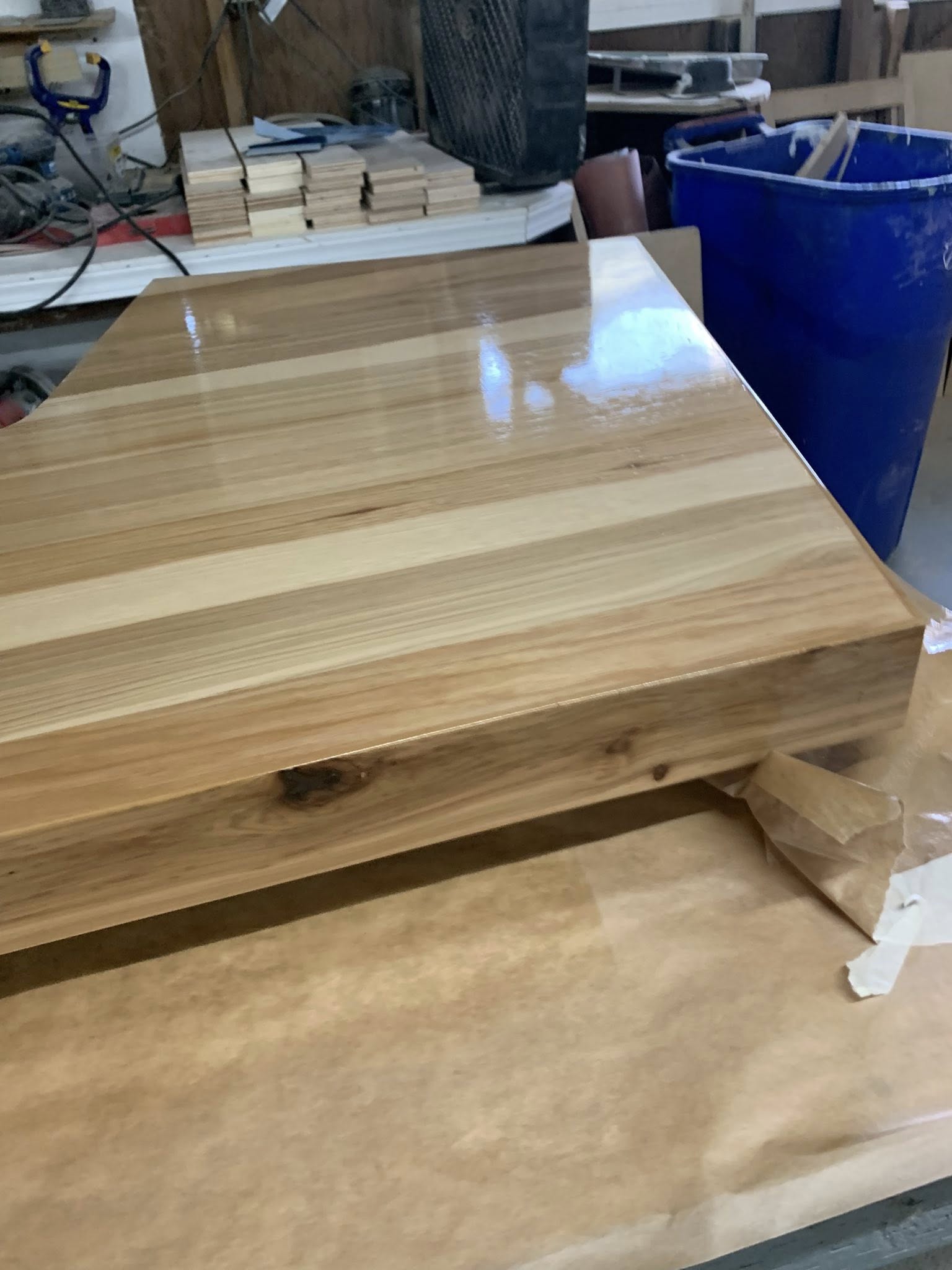 A wooden table resting on a workbench, showcasing craftsmanship and the natural texture of the wood.